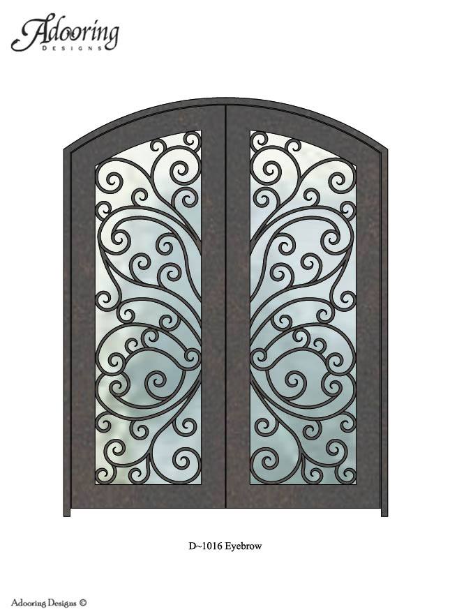 Large window in iron door with eyebrow top and complex pattern