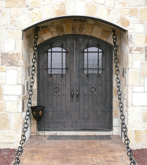 Bronze finish iron front doors that resemble a castle entrance
