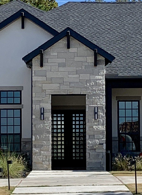 Double front door with square top and design with multiple small squares made of iron