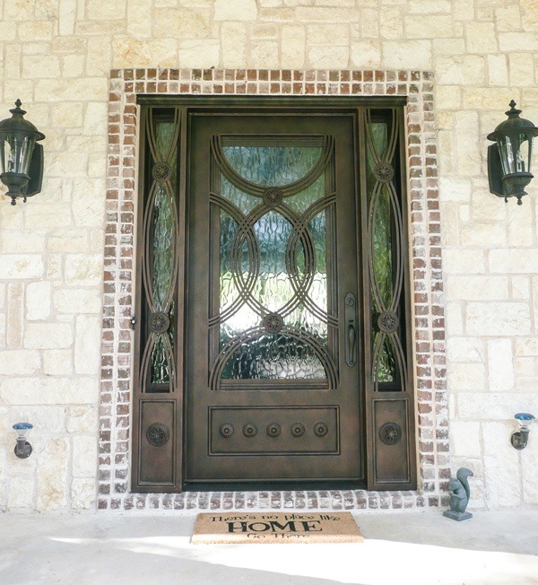 Square top single door with bronze finish and intricate windows in door and on both sides