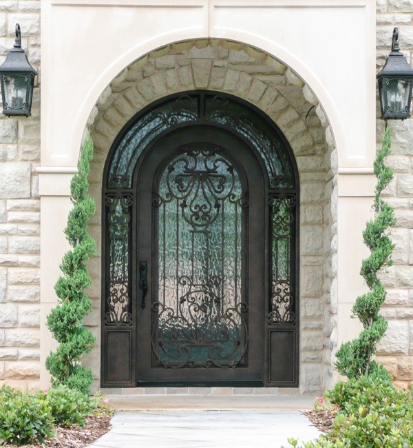 Round top single front door with copper finish surrounded by custom windows