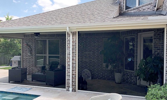 Patio enclosed by motorized screens system