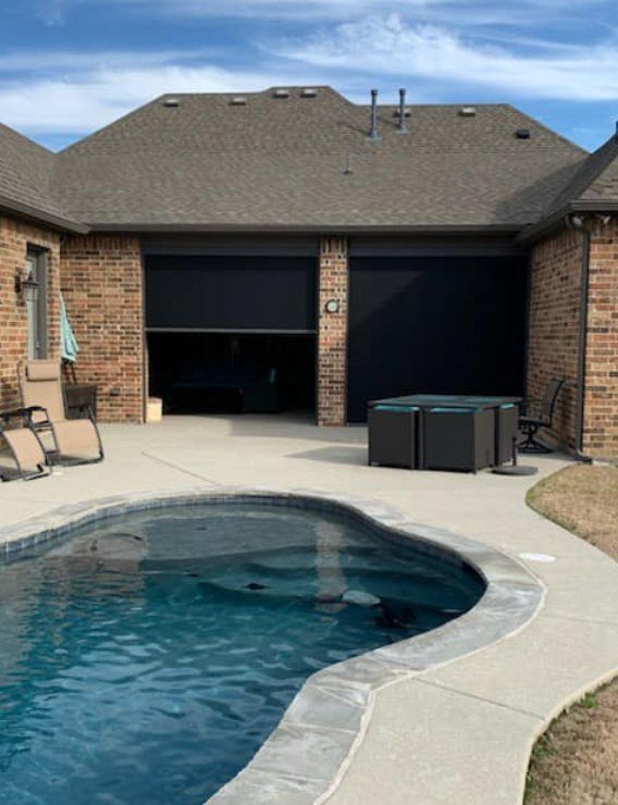 Pool area looking into patio enclosed by motorized shade system