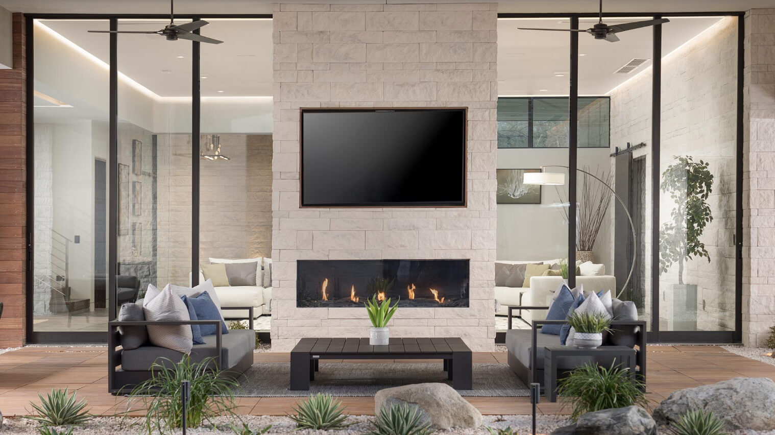 Beautiful outdoor living space looking into home through sliding glass wall