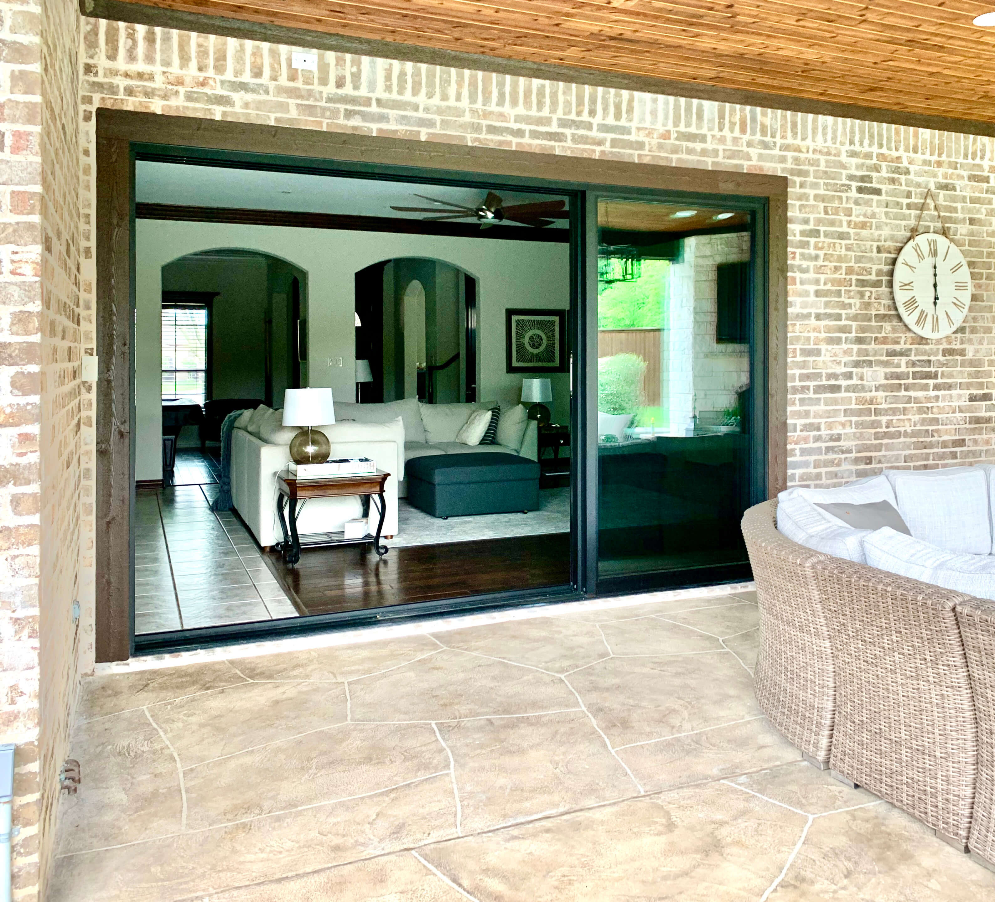 Open sliding glass wall looking into living room