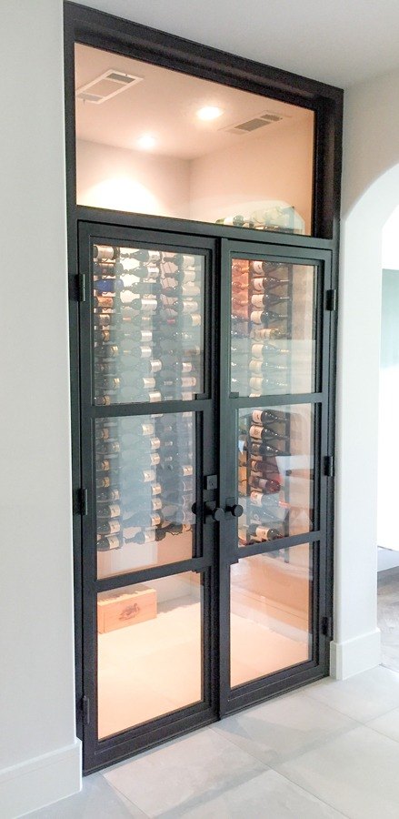 Black finish open doors enclosing wine cellar