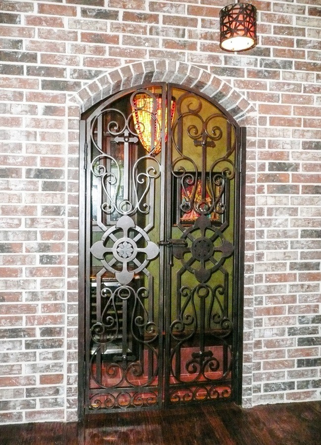 Eyebrow top iron gate into wine cellar