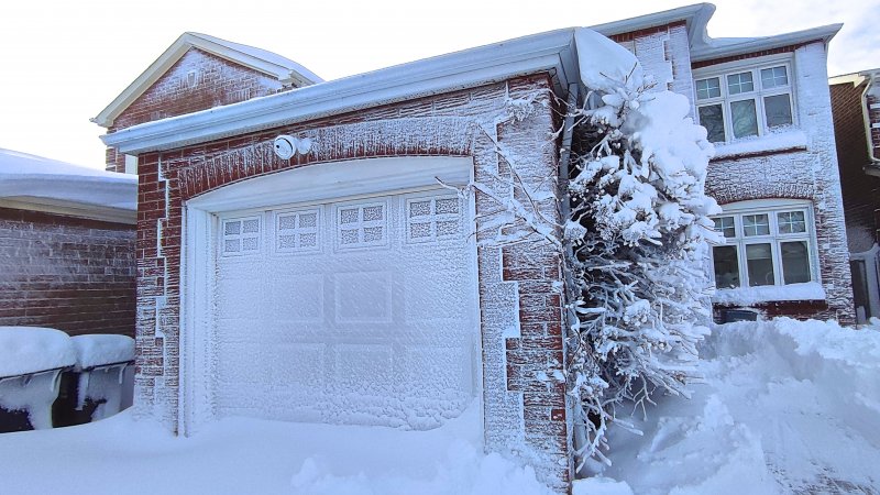 snow and ice on a home and garage door